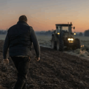 How to Prepare for Spring Planting! Farmer in field with tractor pictured.